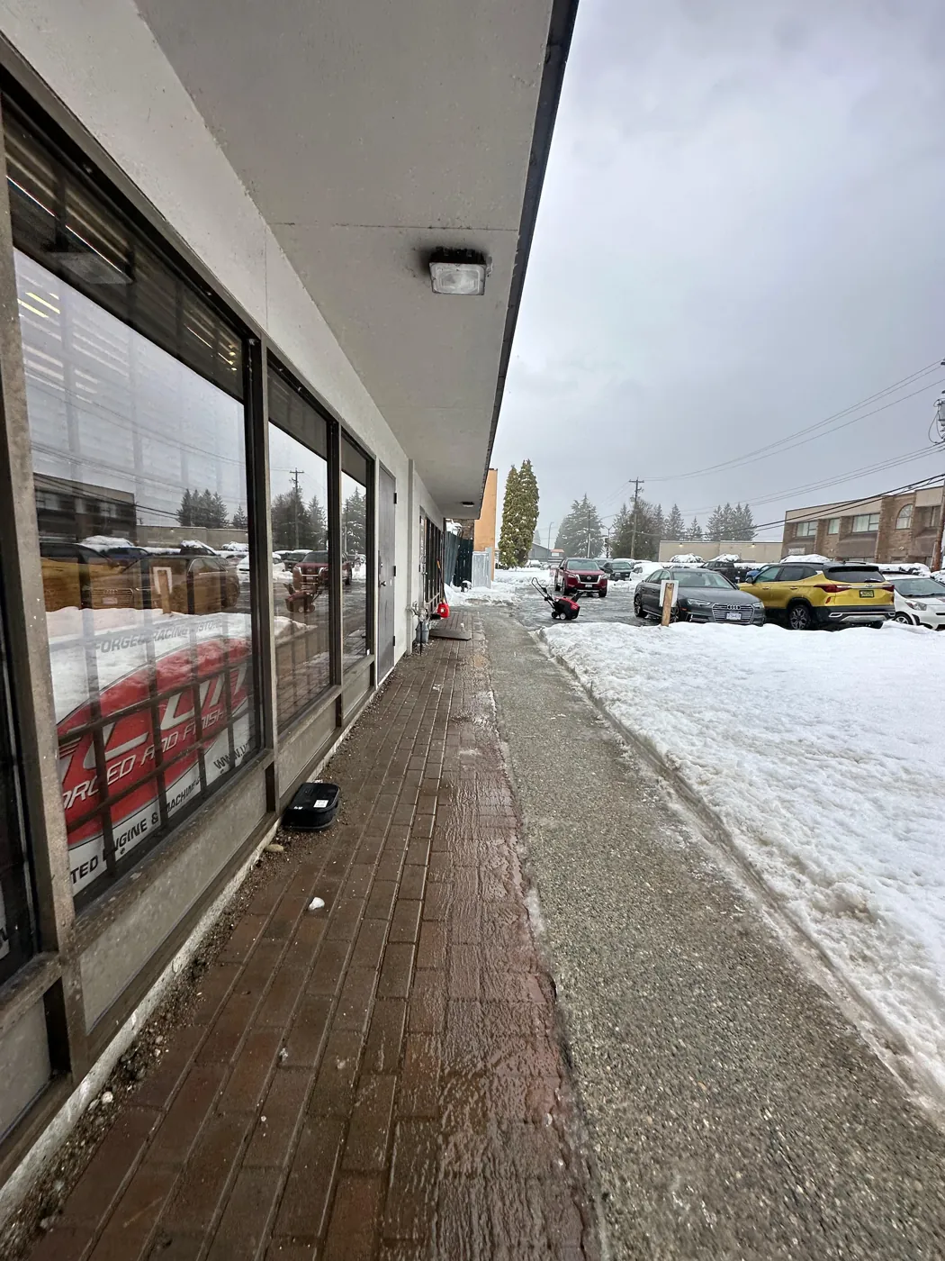 Cleared walkway alongside commercial storefronts